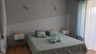 a bedroom with a bed with two towels on it at Sunset Relax Porch in Lagos