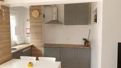 a kitchen with gray cabinets and a white table at Sunset Relax Porch in Lagos