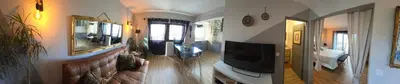 a living room with a flat screen tv on a wall at Sunset Relax Porch in Lagos