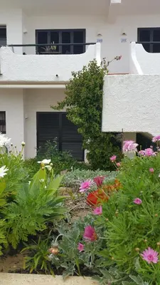 a garden with flowers in front of a house at Sunset Relax Porch in Lagos