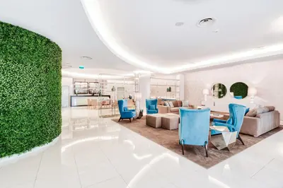 a living room with blue chairs and a couch at Vila Baleira Funchal in Funchal