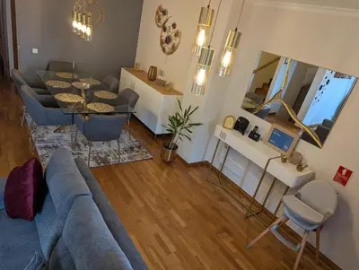 a living room with a blue couch and a table at ZiZis Place in Santa Cruz