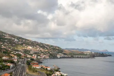 a town on a hill next to a body of water at ZiZis Place in Santa Cruz