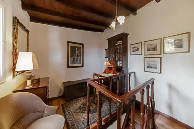 a living room with a staircase and a chair at Quinta Florença - By WeHost in Funchal