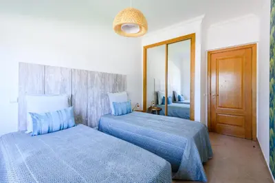 a bedroom with two beds with blue sheets at Boavista in Quatro Estradas