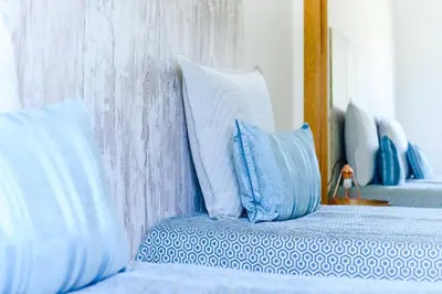 a bedroom with blue and white pillows on a bed at Boavista in Quatro Estradas