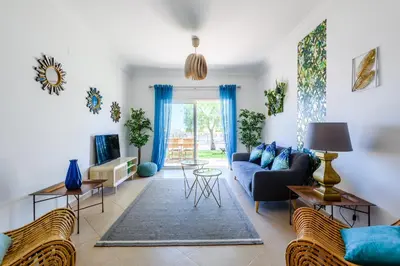 a living room with a blue couch and chairs at Boavista in Quatro Estradas