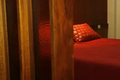 a bedroom with a red bed with a red pillow at Hotel Catedral in Funchal