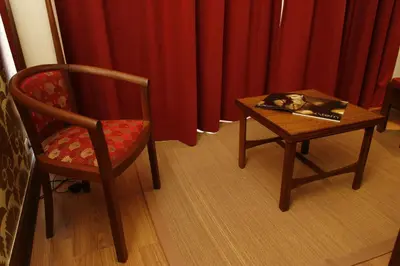 a table and a chair and a book on a table at Hotel Catedral in Funchal