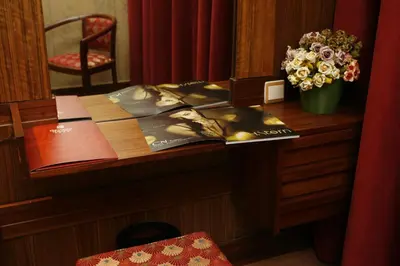a desk with a book and a vase of flowers at Hotel Catedral in Funchal