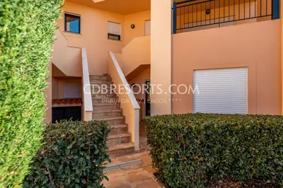 a villa with a staircase leading to a house at Baia da Luz Resort in Luz