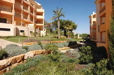 a garden in front of a building at Estrela da Luz Resort in Luz