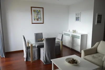 a living room with a table and a dining room at Apartment Ocean Gardens in Caniço