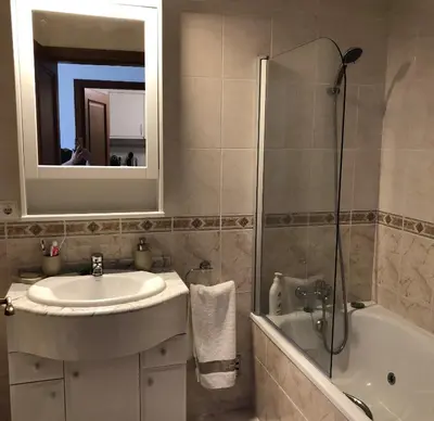 a bathroom with a sink and a shower and a tub at Apartment Ocean Gardens in Caniço