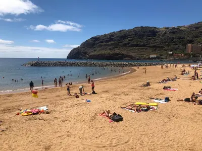 a group of people laying on a beach at Apartment Ocean Gardens in Caniço