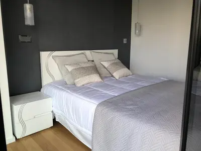 a bedroom with a white bed with pillows at Astro Vista Madeira Apartments in Funchal
