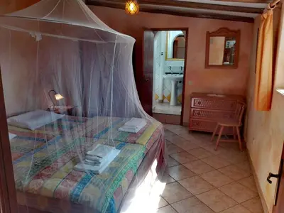 a bedroom with a bed with a canopy at Nature Beach Resort Quinta Al-Gharb in Vila do Bispo