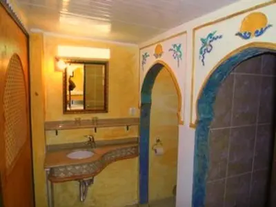 a bathroom with a sink and a mirror at Nature Beach Resort Quinta Al-Gharb in Vila do Bispo