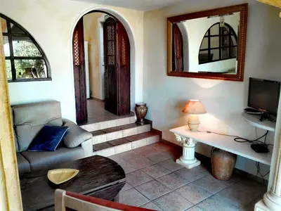 a living room with a couch and a table at Nature Beach Resort Quinta Al-Gharb in Vila do Bispo