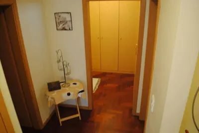 a hallway with a room with a table and a mirror at Pia's Place - Apt with sea view in Caniço