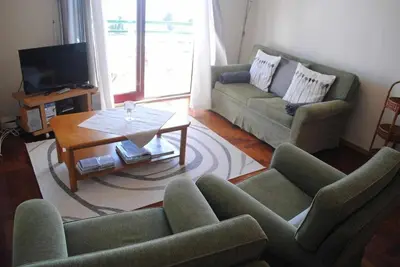 a living room with two couches and a coffee table at Pia's Place - Apt with sea view in Caniço