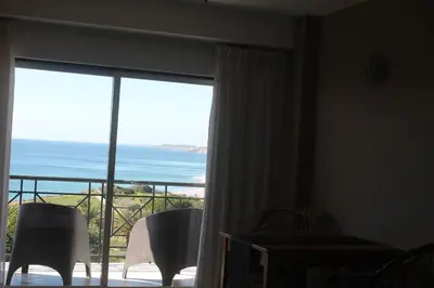 a room with a balcony with a view of the ocean at Vivenda Solmar in Lagos