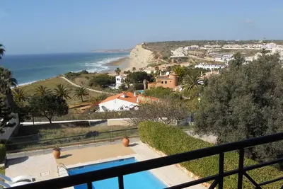 a view of a resort with a swimming pool and the ocean at Vivenda Solmar in Lagos