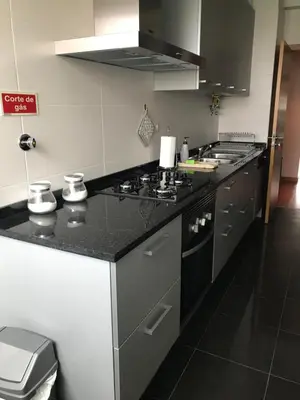 a kitchen with a black and white counter top at Lou-Jos in Funchal