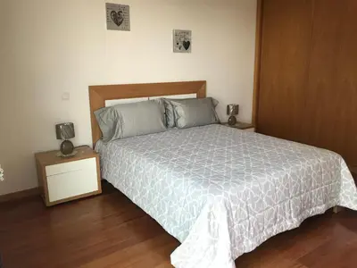 a bedroom with a bed with a white comforter at Lou-Jos in Funchal