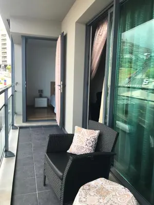 a balcony with a chair and a couch and a window at Lou-Jos in Funchal
