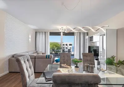 a living room with a couch and a glass table at Madeira Mar - 