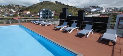 an aerial view of a city and the ocean at Madeira Mar - 