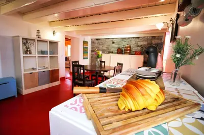 a kitchen with a table with a loaf of bread on a cutting board at Casa Benedita in Ponta do Pargo