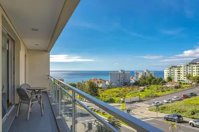 a swimming pool in the middle of a building at Blue Sky Apartment with pool by Holiday Rental Madeira in Funchal