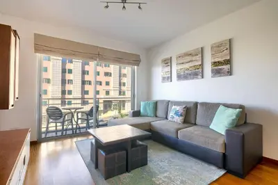 a living room with a couch and a table at Blue Sky Apartment with pool by Holiday Rental Madeira in Funchal