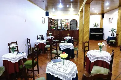 a restaurant with tables and chairs with flowers on them at Hotel GORDON in Funchal