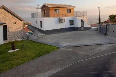 a house with a large parking lot in front of it at OurMadeira - Casa da Rosalina in Calheta
