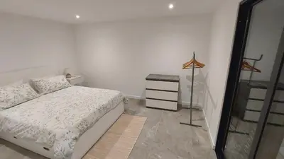 a bedroom with a bed and a dresser in it at Estúdio Laura in Câmara de Lobos