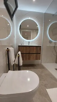 a bathroom with a white toilet and a mirror at Estúdio Laura in Câmara de Lobos