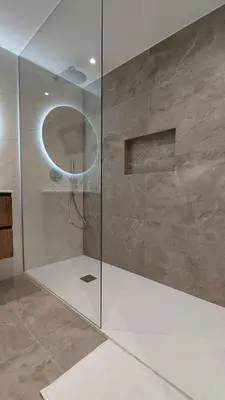 a shower with a glass door in a bathroom at Estúdio Laura in Câmara de Lobos