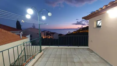 a balcony of a house with a view of the ocean at Estúdio Laura in Câmara de Lobos