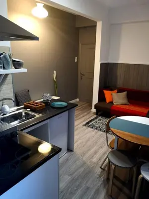 a kitchen and living room with a table and a couch at Apartment Madeira Happiness in Funchal