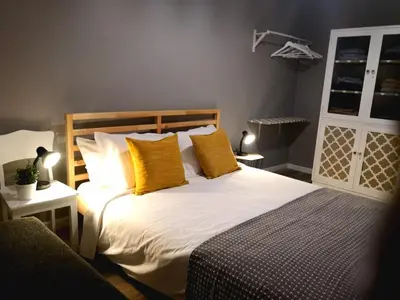 a bedroom with a large bed with yellow pillows at Apartment Madeira Happiness in Funchal