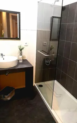 a bathroom with a glass shower and a sink at Apartment Madeira Happiness in Funchal