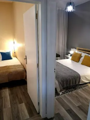 a bedroom with two beds and a sliding door at Apartment Madeira Happiness in Funchal
