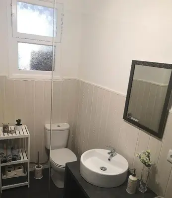 a bathroom with a sink and a toilet and a mirror at Apartment Madeira Happiness in Funchal