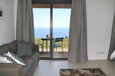 a living room with a couch and a table at OurMadeira - Quinta Inácia in Calheta