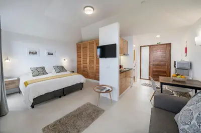 a bedroom with a bed and a living room at OurMadeira - Quinta Inácia in Calheta