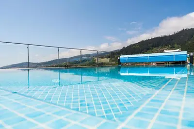 a swimming pool with a view of the water at Valley View-Villa with heated pool and sauna in Arco da Calheta