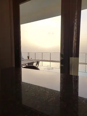 a room with a view of the ocean through a window at Valley View-Villa with heated pool and sauna in Arco da Calheta